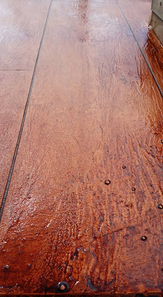 Decorative concrete overlay/resurfacing - trowel finished concrete to look like wood, then coloured with Abstract Dye (mahogany).