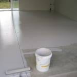 Applying a specialist epoxy paint to a garage floor.